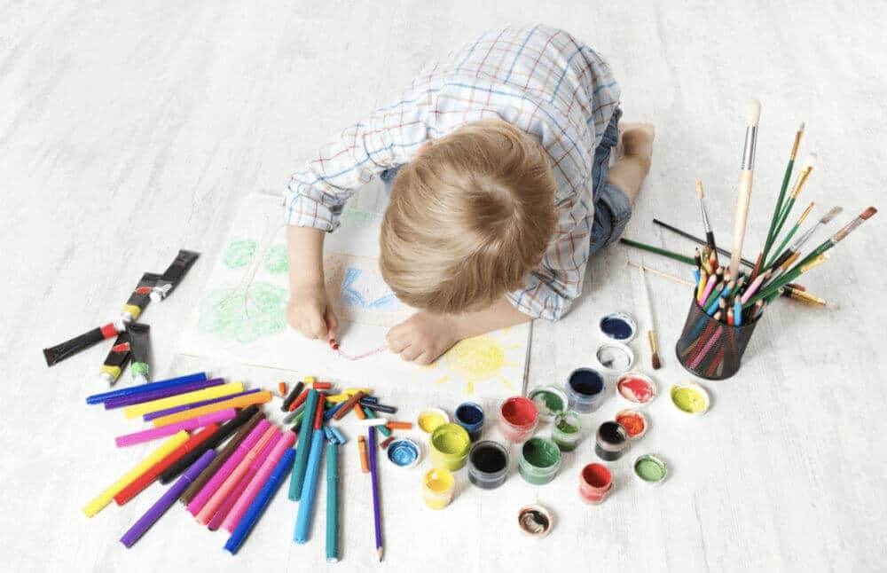 kid drawing with creativity and colour pencils