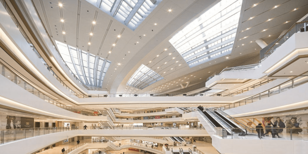 NOTICE THE SPOTLIGHT ON THE ROOF OF THE SHOPPING MALL