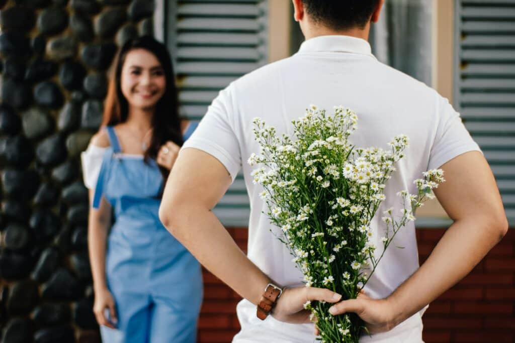 Man hide flowers to woman