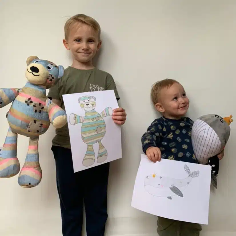 Kids showing their drawings and Bespoke Plush